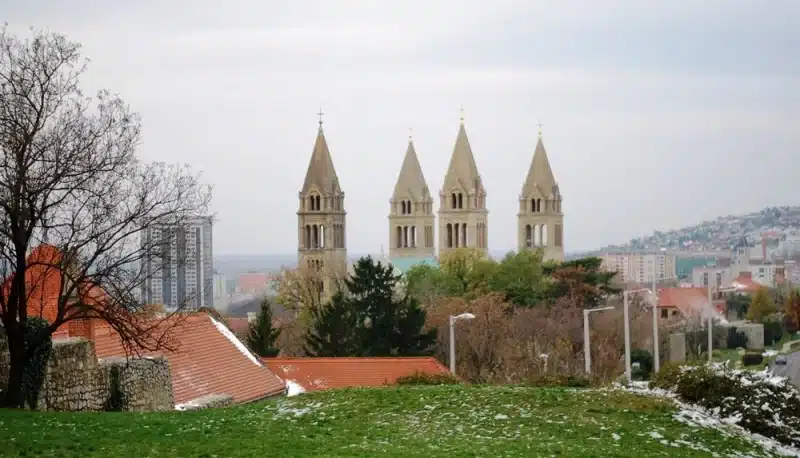 The Cathedral Basilica of Saint Peter and Paul with its tall towers visible over trees