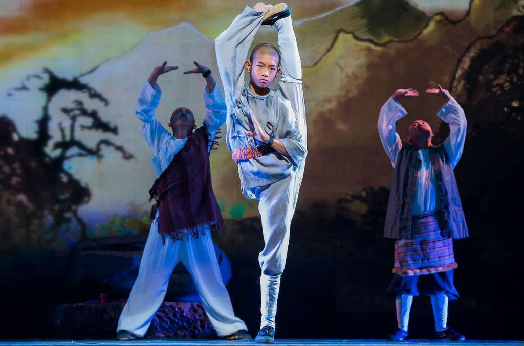 A child Shaolin monk completing a balancing one leg stand