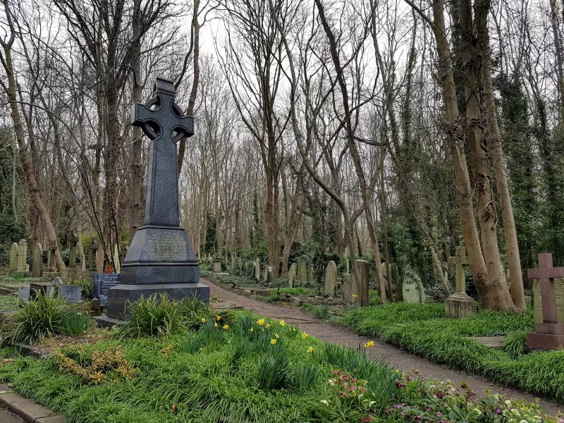Highgate Cemetery in London. Large grey headstone next to path