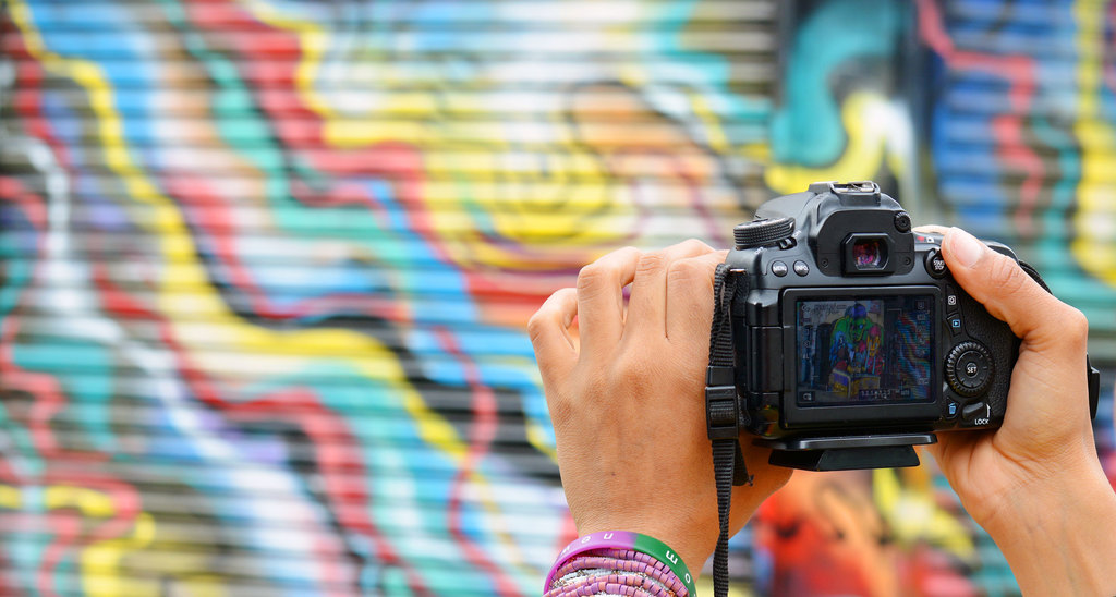 DSLR camera being pointed at some East London street art