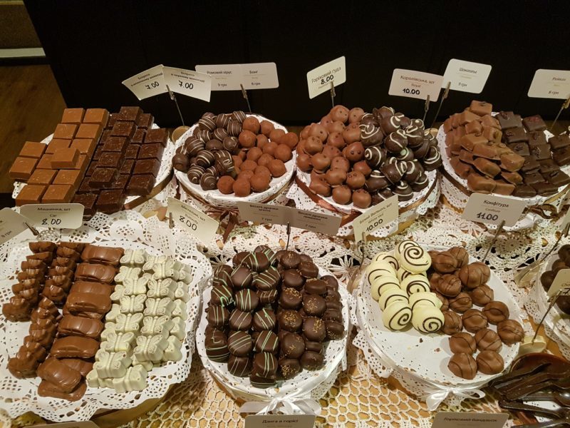 Assorted chocolates on plates on table