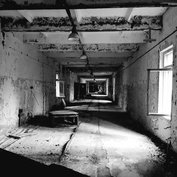 black and white photo chernobyl building corridor