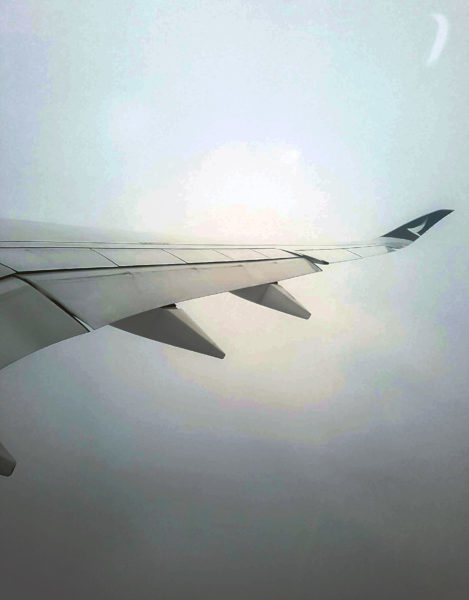 Photo of the plane wing taking through the window. What to expect when embarking on a long haul flight