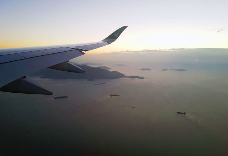 Photo of plane wing, islands can be seen from the window. What to expect when embarking on a long haul flight