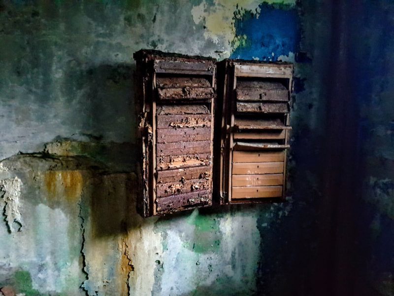 Decaying mailboxes in the lobby of the apartment building Pripyat Chernobyl Photos www.roamingrequired.com