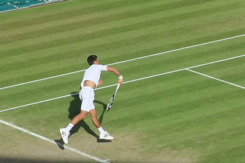 Novak Jokovic playing tennis at Wimbledon