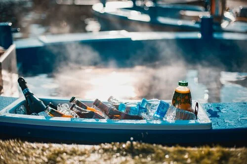 A collection of drinks on the shelf in the hot tub boat