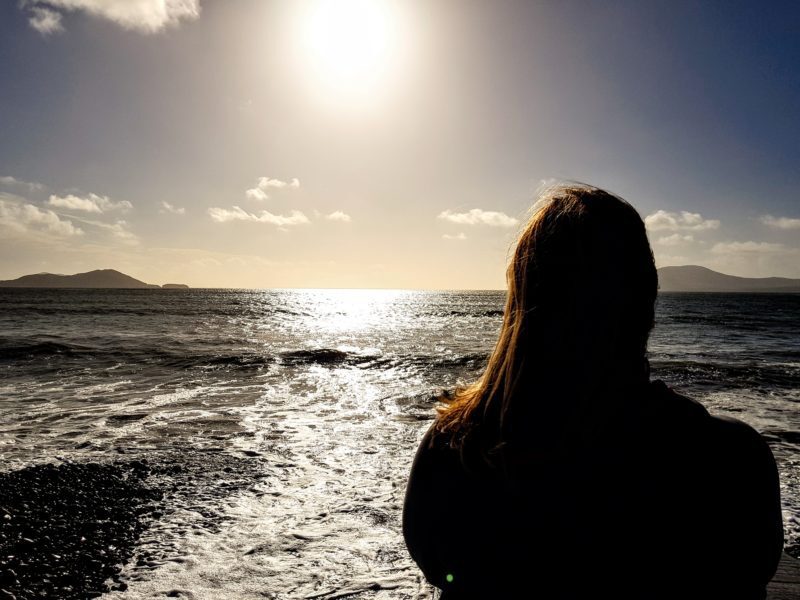 Person looking out at the view of Waterville Beach in Ireland