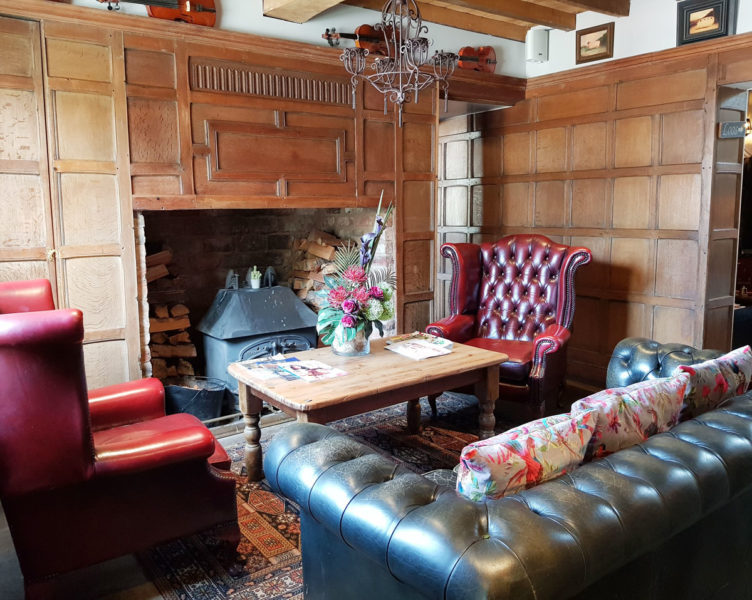 Oxblood red chesterfield sofa at The Vicarage in Holmes Chapel