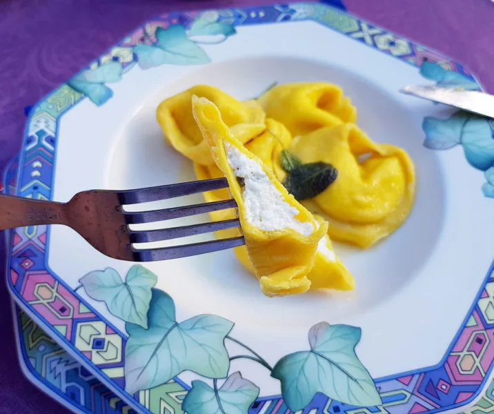 Purple table cloth with Butter and sage Tortelloni. There's so much on offer to eat in Bologna, Italy. Make the most of it and enjoy it all.