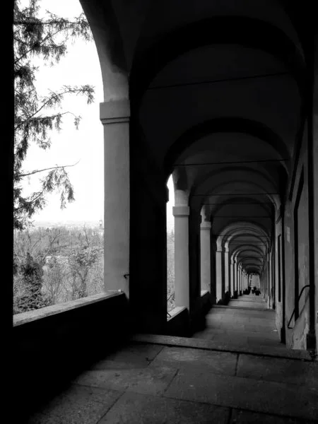 Black and white photo of a stretch of San Luca Bologna porticoes