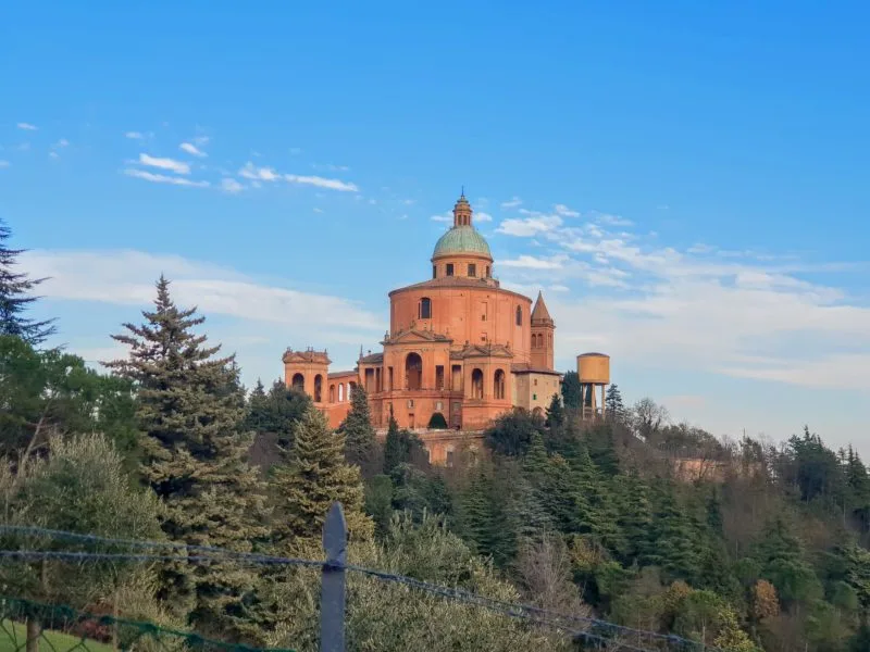 The terracotta-coloured exterior of the San Luca Bologna Monastery