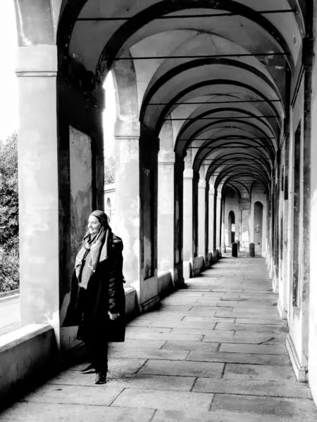 Black and white photo of Roma standing in the San Luca Monastery Porticoes in Bologna Italy