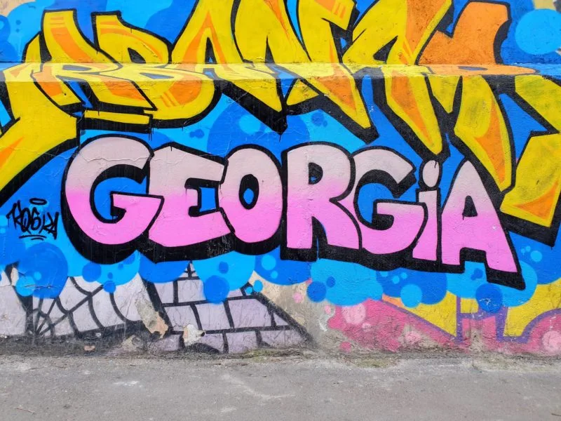 Georgia written in pink paint in one of the pieces of street art seen in Tbilisi Georgia