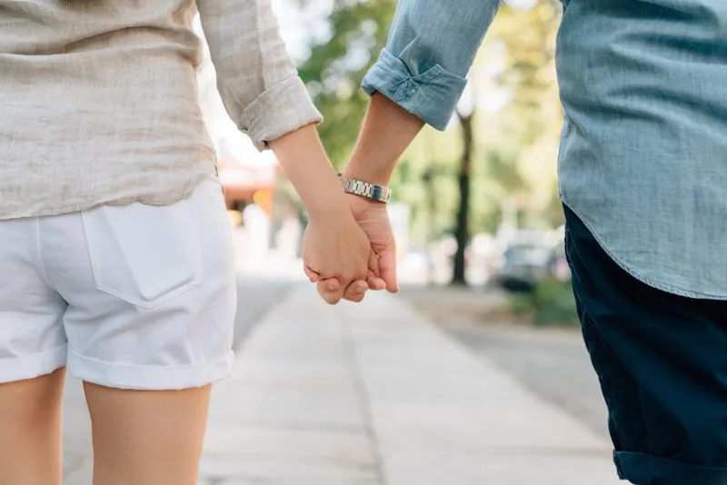 Woman and Man holding hands