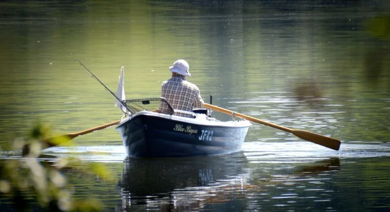 Man in a rowboat on a lake