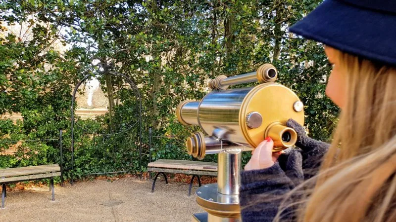 Roma at a telescope at King Henry's Mount