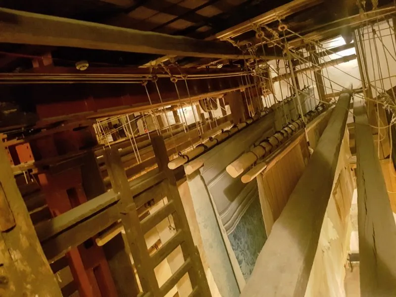 Photo taken from the upper section of the theatre showing the various backdrops side by side which are all controlled by a pulley system