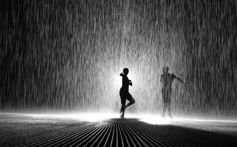 People silhouettes in the Rain Room in Sharjah 