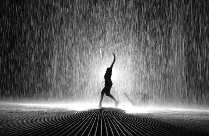 People silhouettes in the Rain Room in Sharjah 