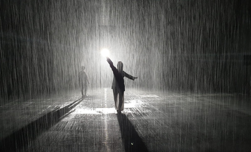 People silhouettes in the Rain Room in Sharjah 