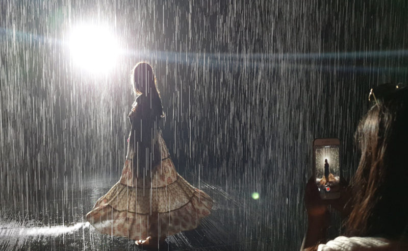 People silhouettes in the Rain Room in Sharjah 