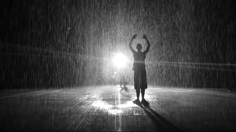 People silhouettes in the Rain Room in Sharjah 