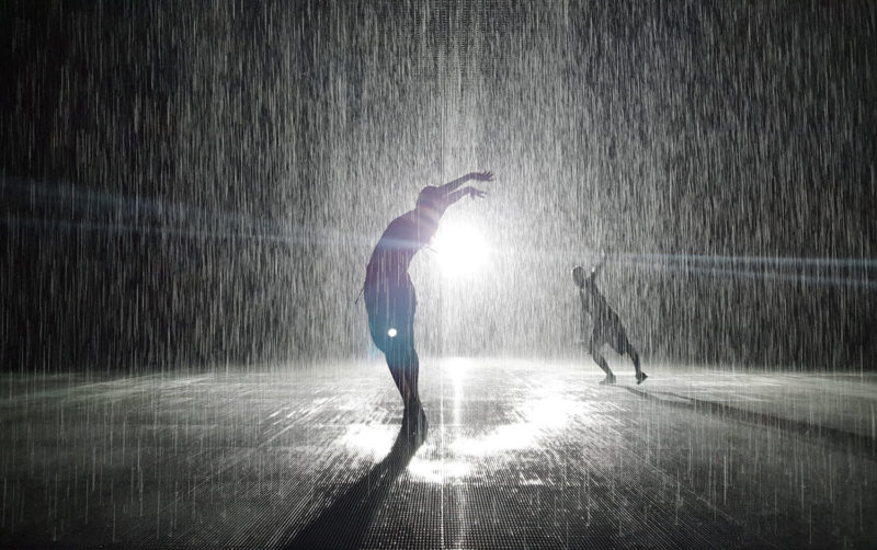 People silhouettes in the Rain Room in Sharjah 