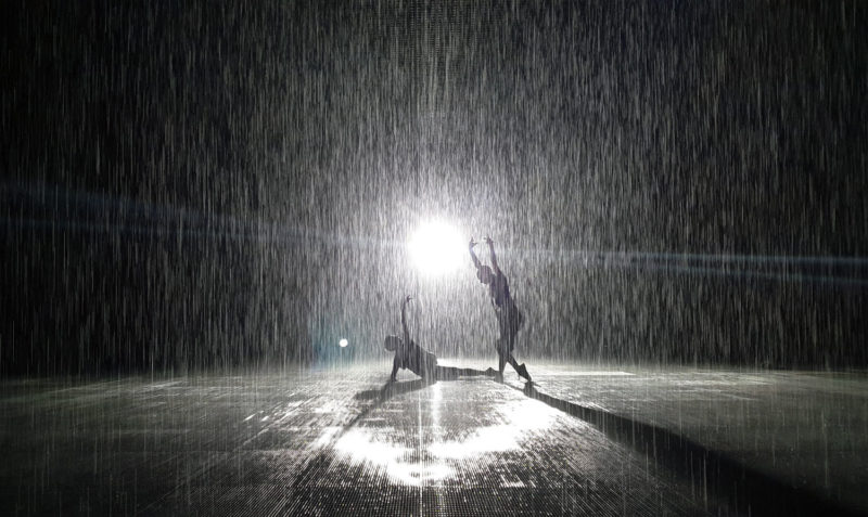 People silhouettes in the Rain Room in Sharjah 