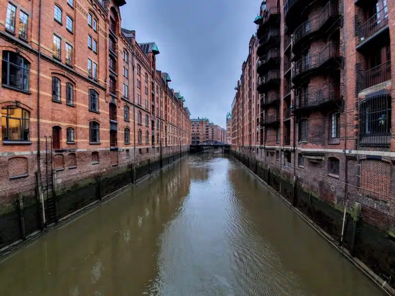 Speicherstadt District with waterway between warehouses. A visit to the Speicherstadt is a great way to spend one day in Hamburg