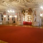 Large state room with red carpet and multiple chandeliers hanging from the ceiling. Friedenstein Castle, Gotha www.roamingrequired.com