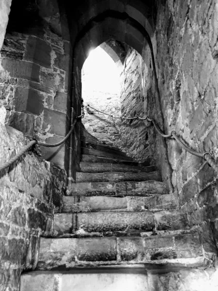 Black and white photo of stone stairwell at Battle Abbey 