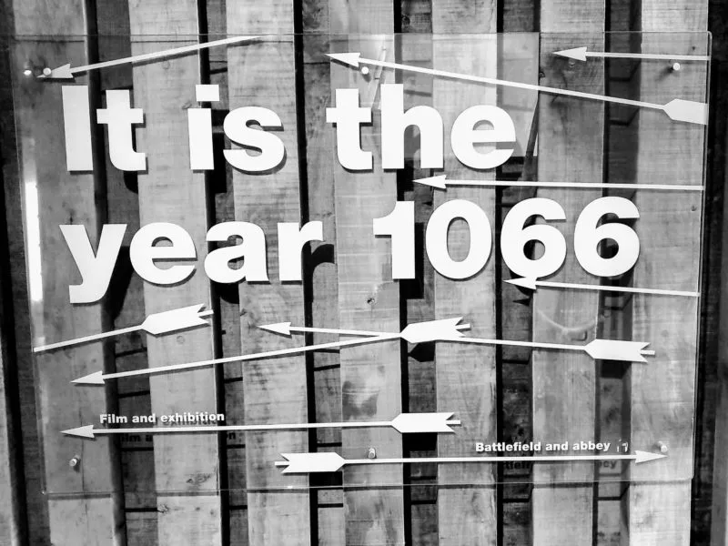 Black and white photo of sign displaying "it is the year 1066" in the Battle Abbey Visitor Centre