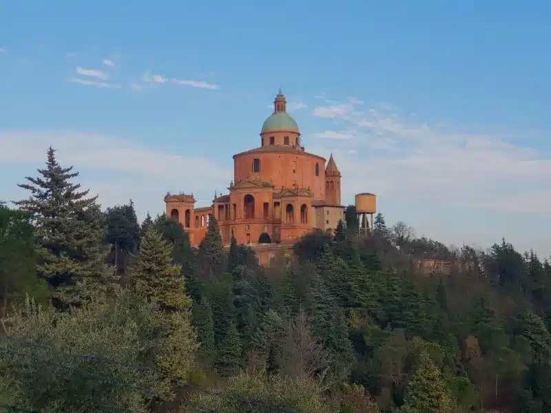 The exterior of the San Luca Monastery rising above the treetops