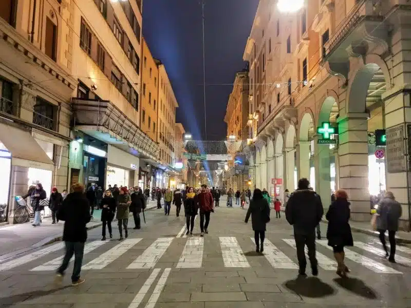 People walking along the Via Emilia in Bologna Italy