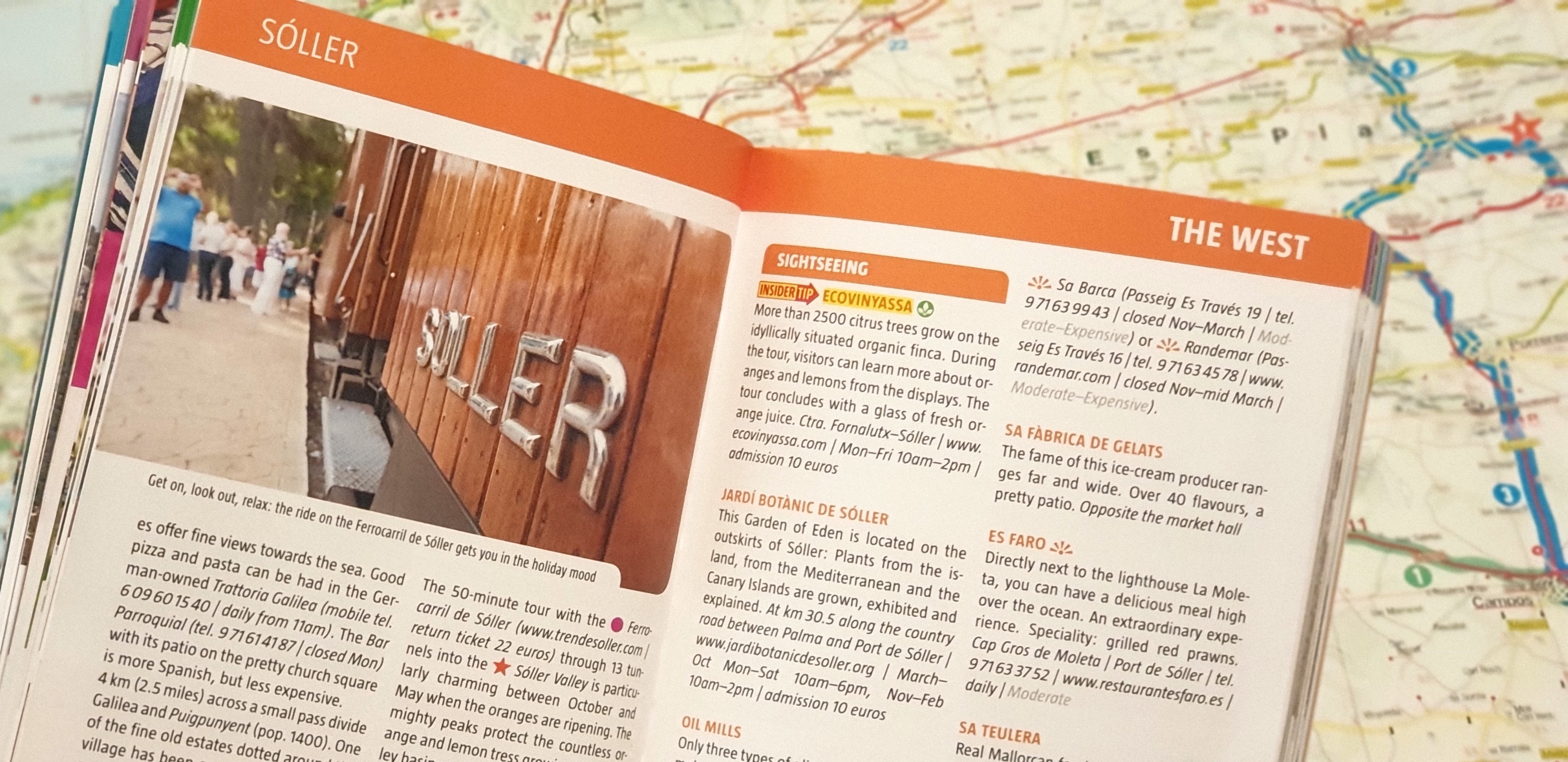 Marco Polo Guide Book open over a map of Soller and Mallorca