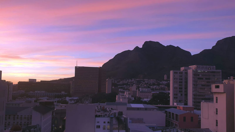 Gorgeous sunset over Cape Town with sky of pinks and purple colours. Table Mountain is in the background