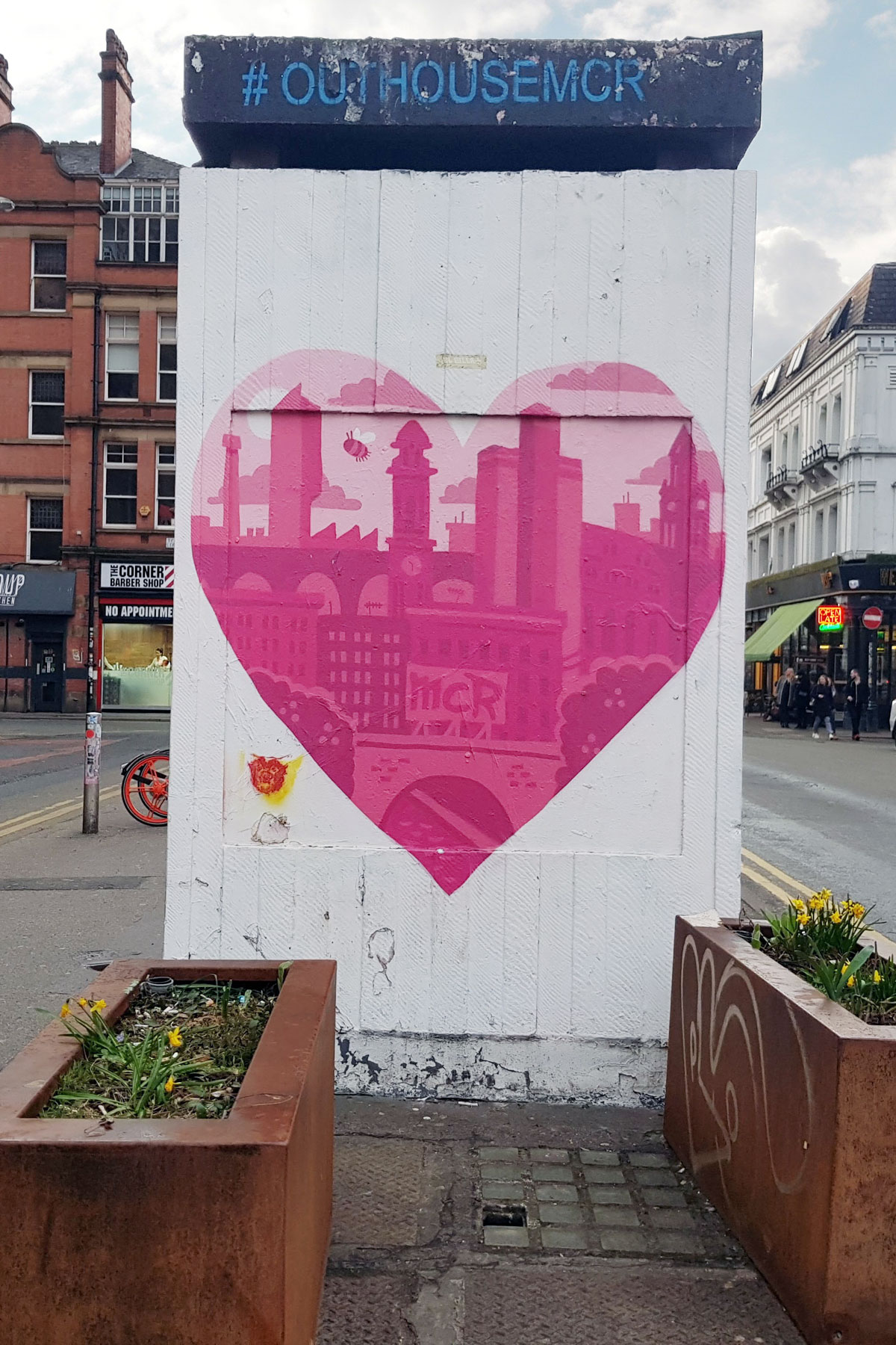 Pink and white heart street art in Manchester. 