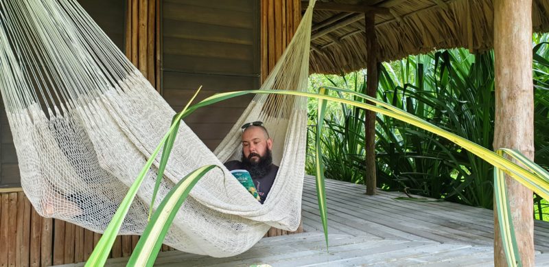 Russ reading a book in a hammock in Belize