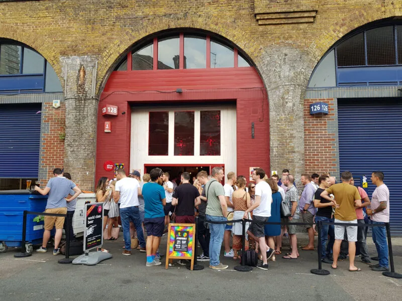 Crowd of people standing in front of one of the many bars along the Bermondsey Beer Mile