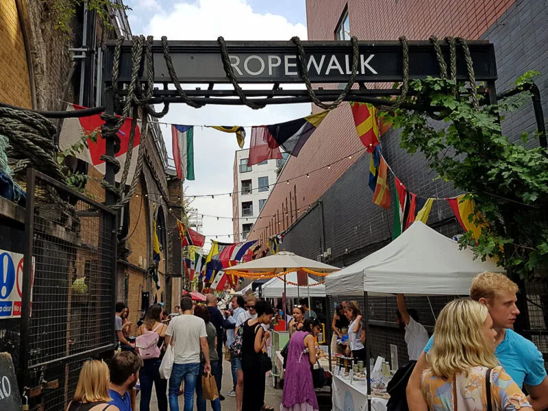 Crowds of people standing in Maltby Street Market