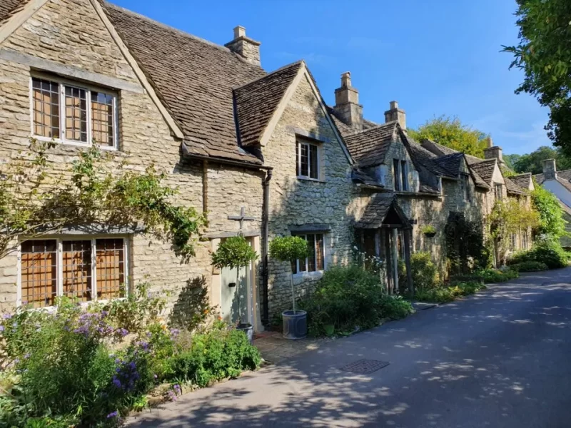 Stone buildings with a street running in front of them. Just one of many places for day trips in London.