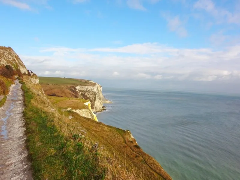 The white cliffs of Dover. Walking trail can be seen against cliffs and channel views. Just one of many places to include on this list of day trips from London by car