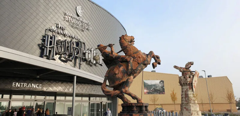 Warner Bros Studios the making of Harry Potter. Exterior of studios with statues of knight and rook from Wizard's Chess. Just one of many places to include on this list of day trips from London by car 