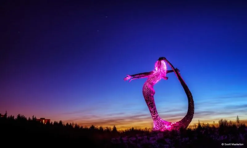 Arria at night lit up with a pink light
