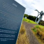 Arria sign with details of sculpture in focus with Arria sculpture blurred in the background