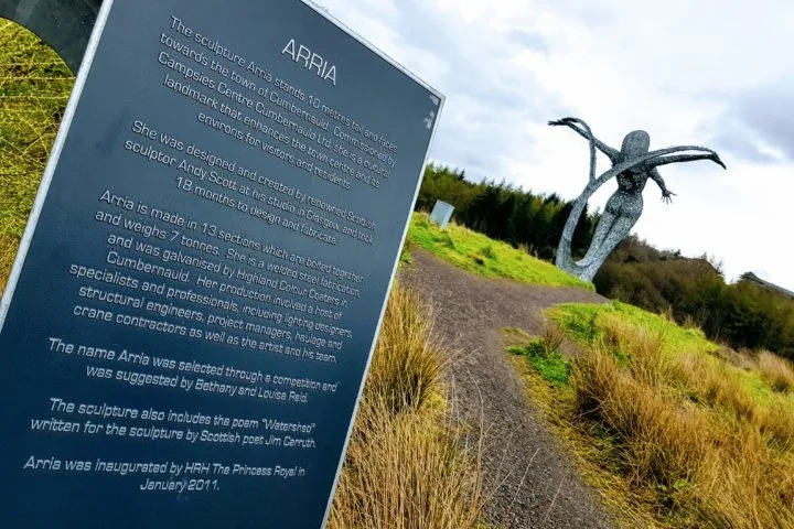 Arria sign with details of sculpture in focus with Arria sculpture blurred in the background