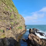 People walking along The Gobbins coastal path set along the basalt cliffs.