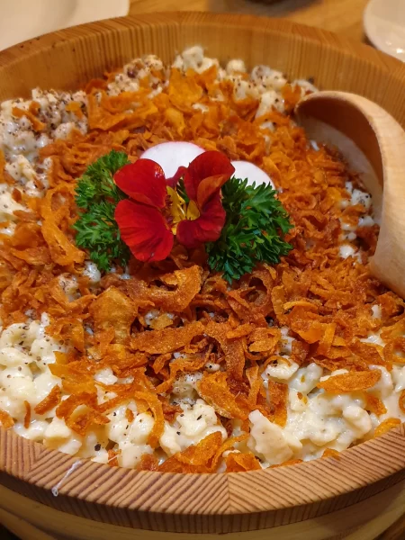 Close up of Kässpätzle with crispy fried onions sitting on top of the creamy cheese. Just one of many things to do in Feldkirch Austria.