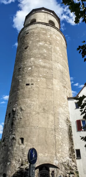 The tall tower in the middle of a portrait photo. Blue skies can be seen at the edge of the photo around the Katzenturm Tower. Just one of many things to do in Feldkirch Austria.